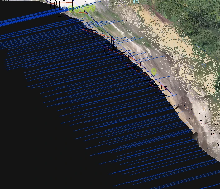 Vue latérale du terrain relevé en nuage de points sur fond noir, avec les ancrages dessinés en bleu pour les essais d’ANCRIA 3D et les positions du projet figurées par des carrés noirs.
